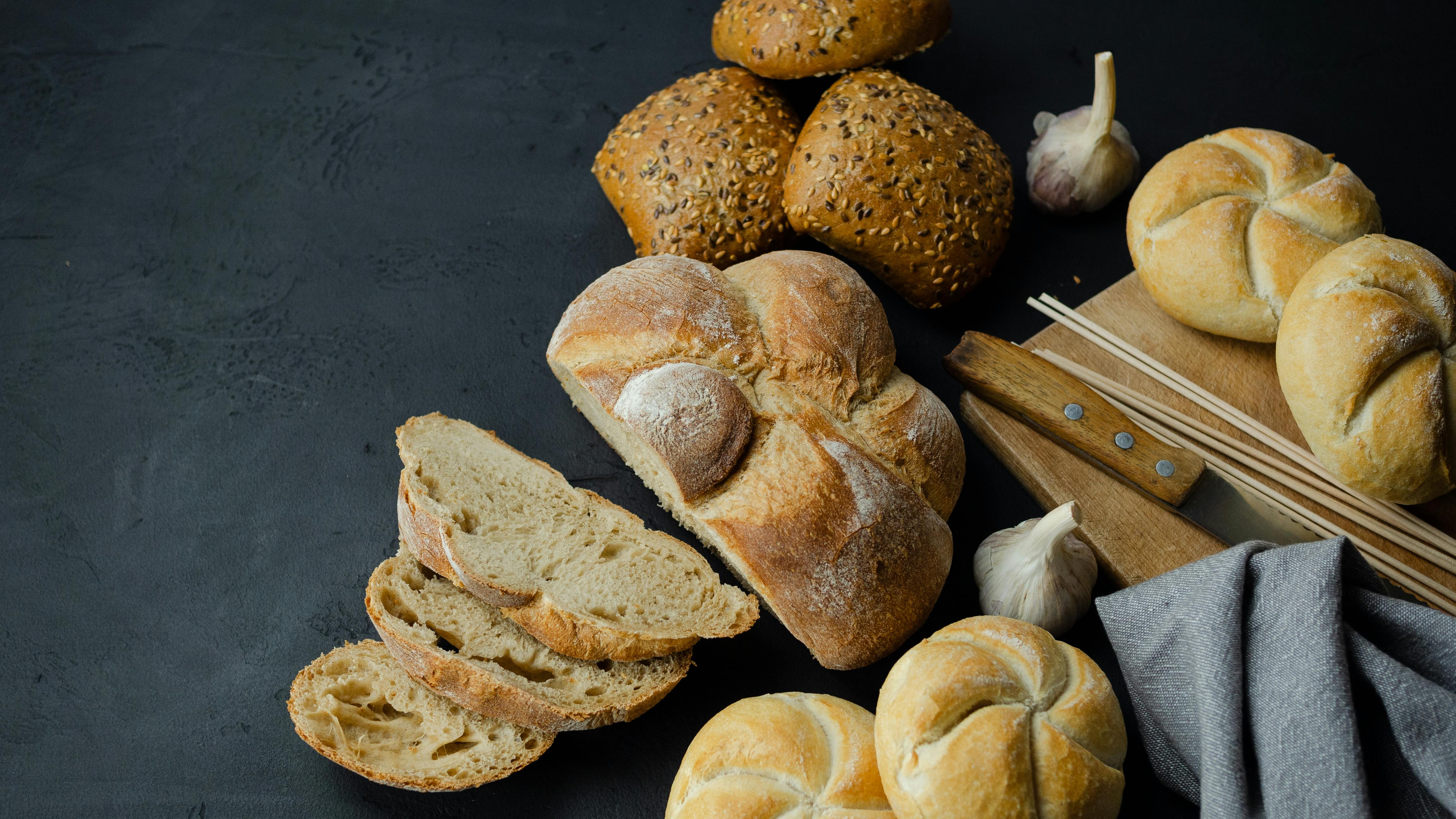 Artisan protein breads on dark surface — Powerhouse Pastries